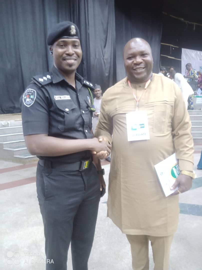 Comr. Dr Atigwe Henry Ifeanyi shaking hands with a Nigeria Police officer at a youth event